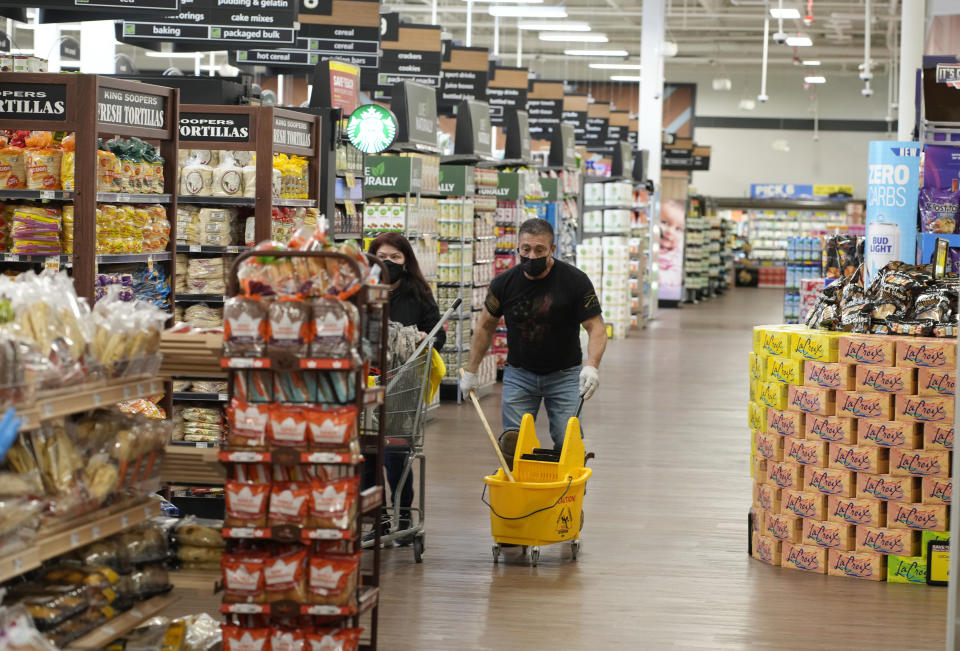 Workers put the finishing touches as they clean the Table Mesa King Soopers during a media tour Tuesday, Feb. 8, 2022, in Boulder, Colo. Ten people were killed inside and outside the store when a gunman opened fire on March 22, 2021. The store reopens with new renovations on Wednesday, Feb. 9. (AP Photo/David Zalubowski)