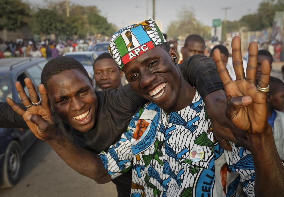 Supporters of President Muhammadu Buhari celebrate the announcement of results favoring his All Progressives Congress (APC) party in their state, anticipating victory, in Kano, northern Nigeria Monday, Feb. 25, 2019. Nigeria's electoral commission on Monday began announcing official results from the country's 36 states as President Muhammadu Buhari seeks a second term. (AP Photo/Ben Curtis)