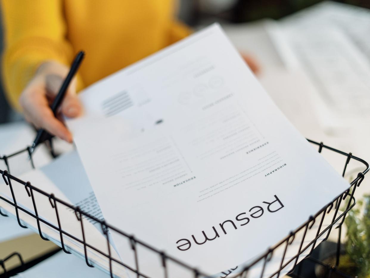 Woman sorting résumés.