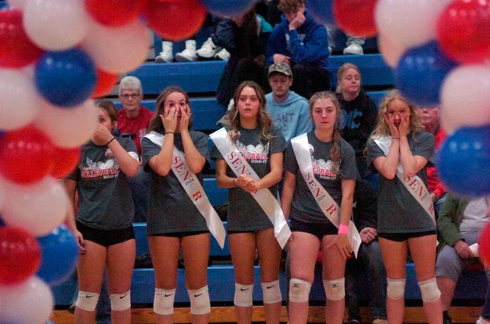 Mapleton seniors Emilee Dennison, Jillian Grundy, Eastyn Rohr and Rhyannon Schrader share in an emotional senior recognition ceremony that honored late teammate Bre McKean before the start of volleyball action.