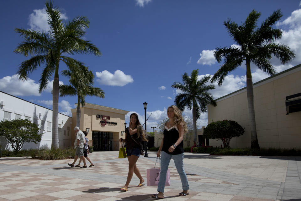 In this March 6, 2012 photo, Daniela Dias, right, and her sister Natalia, from Brazil, shop at the Sawgrass Mills mall in Fort Lauderdale, Florida. Brazilian travelers spend more per capita than any other visitors to the U.S. (AP Photo/Felipe Dana)