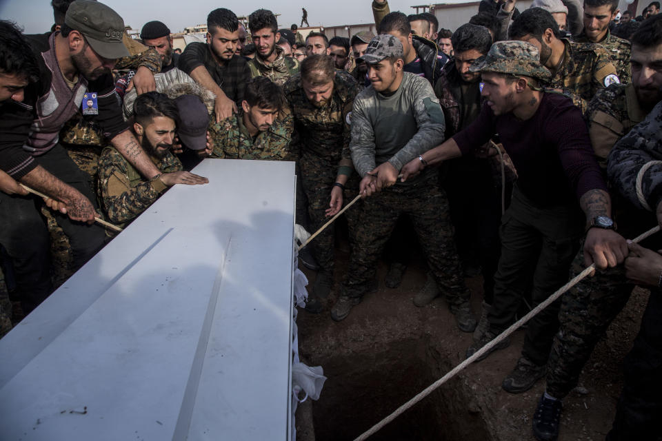 Comrades burry Said Abdel Ahad, a Christian fighter of the Syriac Military Council, during his funeral in Hassakeh, Syria, Friday, Nov. 22, 2019. Ahad was killed in Turkish offensive near Tal Tamr. (AP Photo/Baderkhan Ahmad)