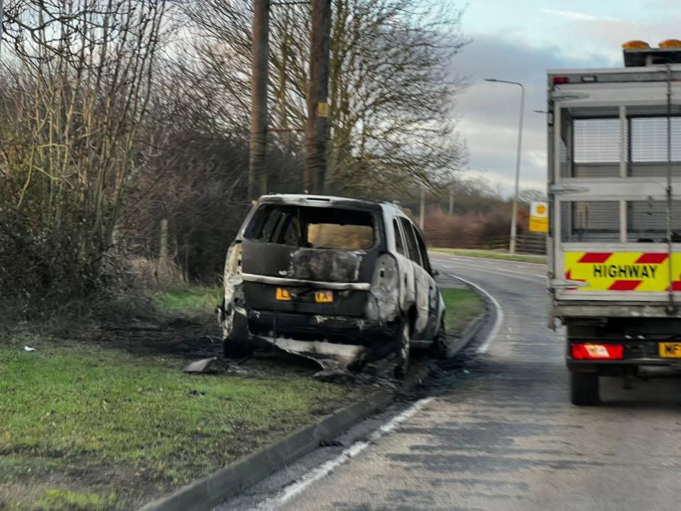 Echo: A burnt out Vauxhall Zafira was spotted at the side of the road. 