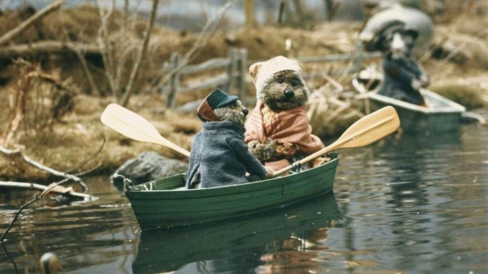 emmet otter and his mom take a trip in a rowboat in a scene from emmet otter's jug band christmas, a good housekeeping pick for best christmas movies for kids