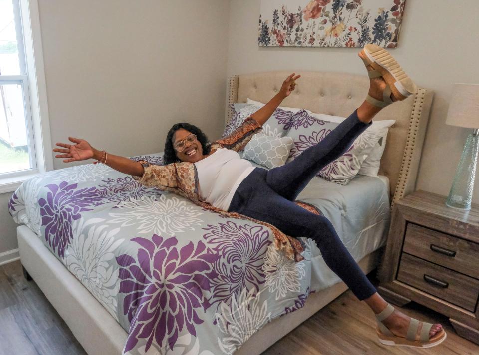 Nick and Terry Saban help dedicate the 20th house funded by the Nick's Kids Foundation for Habitat for Humanity Friday, June 2, 2023, on Elm Street in Tuscaloosa. New homeowner Richelle Harris jumps onto her bed as she celebrates her new home.