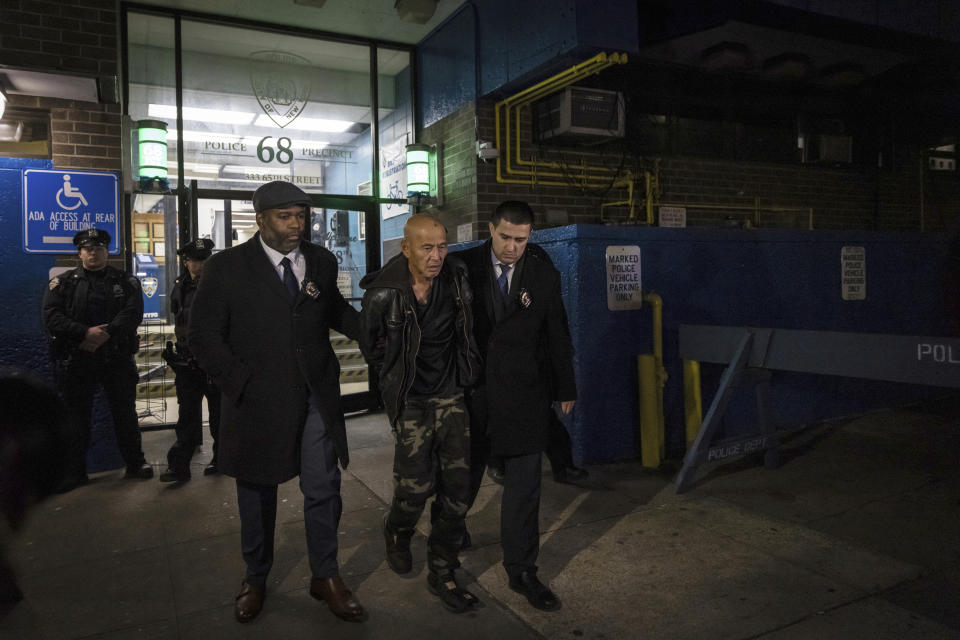 Weng Sor is walked by New York Police Department detectives out of the 68th Precinct in the Brooklyn borough of New York on Tuesday, Feb. 14, 2023. Sor was charged Tuesday with murder and attempted murder after he went on a deadly rampage with a U-Haul truck a day earlier in New York City. (AP Photo/Stefan Jeremiah)