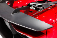 Starting with the everyday 700-hp Aventador, Lamborghini taunted the bull even further by removing the roof, adding several aerodynamic panels and generally shucking weight from a car that only had 3,472 lbs. to begin with. Even the seat fabrics have been swapped for something Lamborghini calls "Carbonskin," a fabric made from carbon fibers that's at least a decade away from being used on a teenager's hat. With no windshield, the interior has to get some form of waterproofing; the rear mirror pops up like Wall-E's head from the center of the dash. It and the roll bars behind the driver are the highest points in the car.