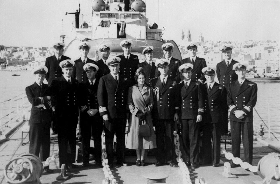 The Duke of Edinburgh and Captain John Edwin Home McBeath DSO, DSC, RN (left), pose with Queen Elizabeth II and the officers of HMS Chequers, during the Boxing Day visit to the destroyer that the Duke is currently serving on. The Duke would go on to Command HMS Chequers   (Photo by PA Images via Getty Images)