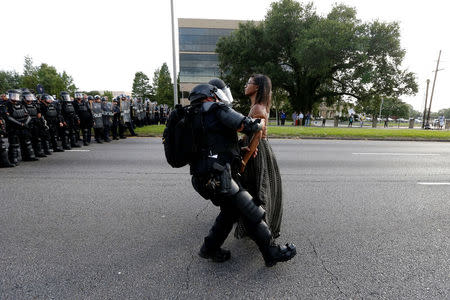 Protestor Ieshia Evans is detained by law enforcement near the headquarters of the Baton Rouge Police Department in Baton Rouge, Louisiana, U.S. July 9, 2016. REUTERS/Jonathan Bachman