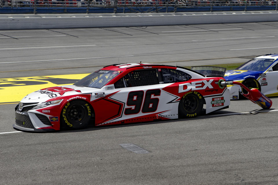 NASCAR driver Harrison Burton drives away with his gas can still attached after a pit stop during the Geico 500 NASCAR Sprint Cup auto race at Talladega Superspeedway Sunday, April 25, 2021 in Talladega, Ala. (AP Photo/Butch Dill)