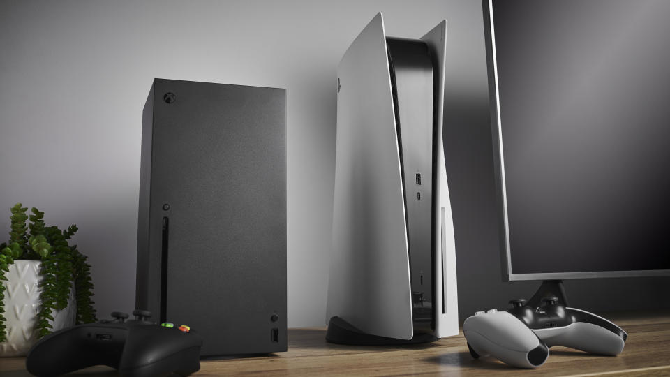 Living room with Microsoft Xbox Series X (L) and Sony PlayStation 5 home video game consoles alongside a television and soundbar, taken on November 3, 2020. (Photo by Phil Barker/Future Publishing via Getty Images)