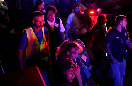 Walmart employees and shoppers leave the scene of a shooting at a Walmart in Thornton, Colorado November 1, 2017. REUTERS/Rick Wilking