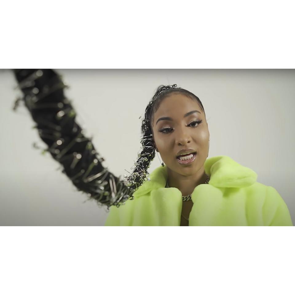 Dancehall artist Shenseea wore this mile-long braid decorated with a crap-ton of safety pins for her "<a href="https://www.youtube.com/watch?v=al_71SuZ2x0" rel="nofollow noopener" target="_blank" data-ylk="slk:Trick'a Treat;elm:context_link;itc:0;sec:content-canvas" class="link ">Trick'a Treat</a>" music video. Her look is a great example of how you can transform a simple high pony with the right accessories. If you've got a bunch of safety pins in a junk drawer somewhere, now you've got a use for them.