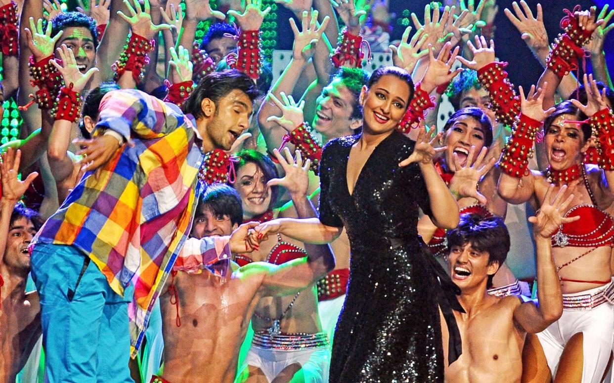 Sonakshi Sinha (R) and actor Ranbir Singh dance during 2011 International Indian Film Academy (IIFA) awards at the Rogers Centre in Toronto