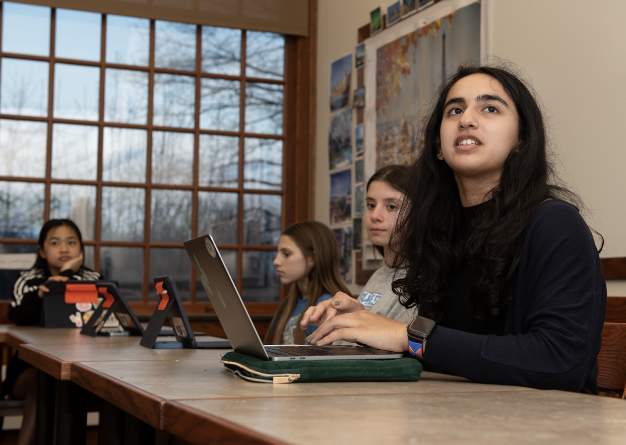 Riya Hegde, a junior at Western Reserve Academy in Hudson, recently started a project called Python Pals. Hegde, who received the NEO High School Microgrant Program to fund her endeavor, reads from the monitor at the front of the room that is running codes.