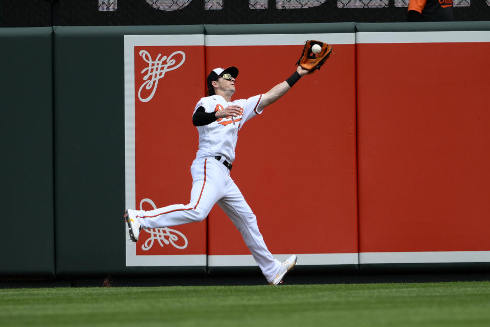 Baltimore Orioles left fielder Austin Hays (21) catches a fly ball for an out hit by New York Yankees' DJ LeMahieu during the first inning of a baseball game, Thursday, May 19, 2022, in Baltimore. (AP Photo/Nick Wass)