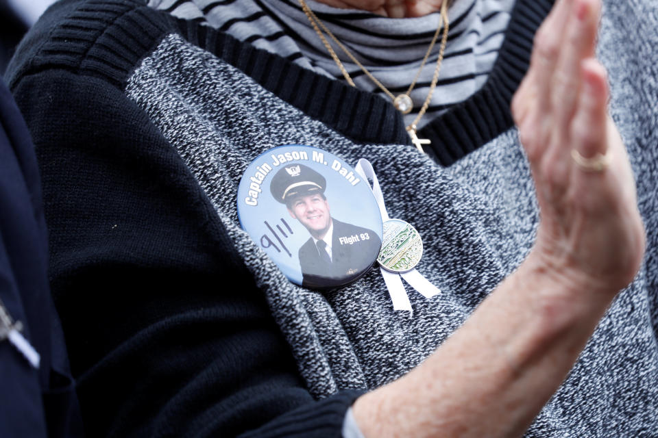 <p>A woman wearing a button of late United Airlines Flight 93 Captain Jason Dahl applauds during the 17th annual September 11 observance at the Flight 93 National Memorial near Shanksville, Pa., Sept. 11, 2018. (Photo: Kevin Lamarque/Reuters) </p>