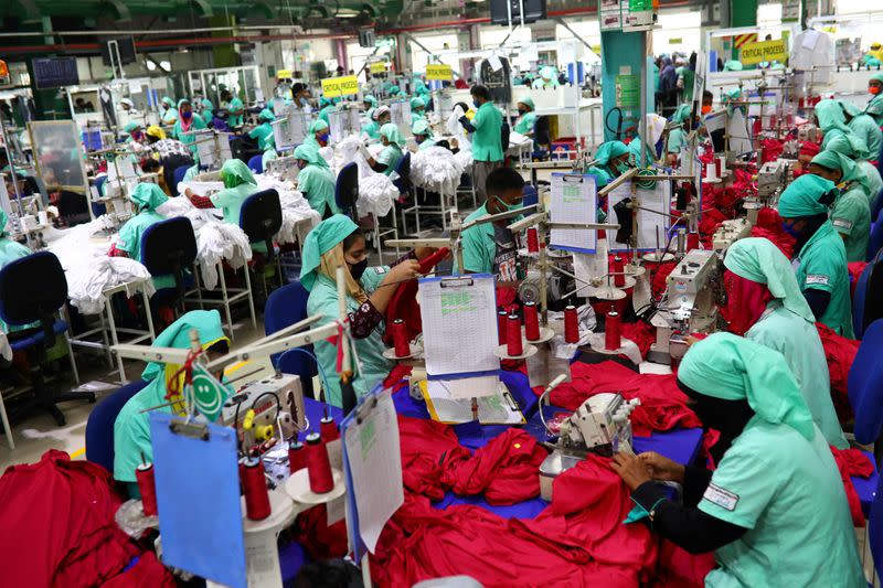 FILE PHOTO: Garment employees work in a sewing section of the Fakhruddin Textile Mills Limited in Gazipur