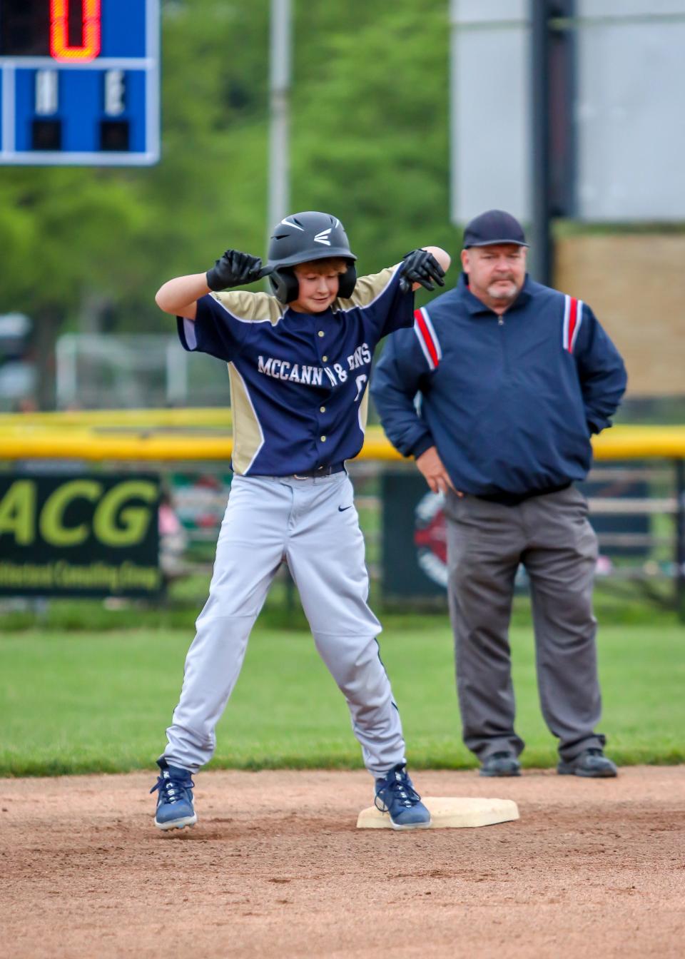 Cayson Stupalski of McCann & Son's reacts after reaching second base in recent action at Whaling City Youth Baseball.