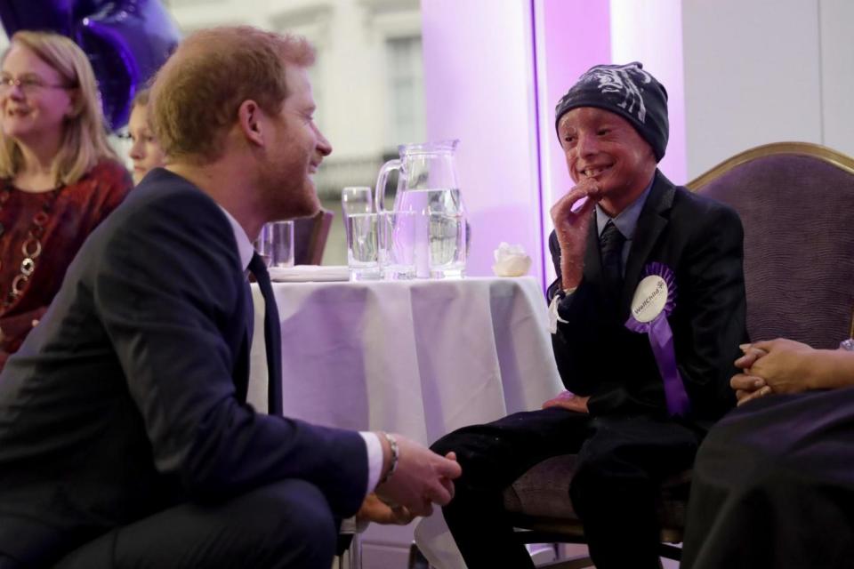 Prince Harry meets Marni Ahmed, aged nine, the winner of the Inspirational Child Award aged seven to 10. (PA)