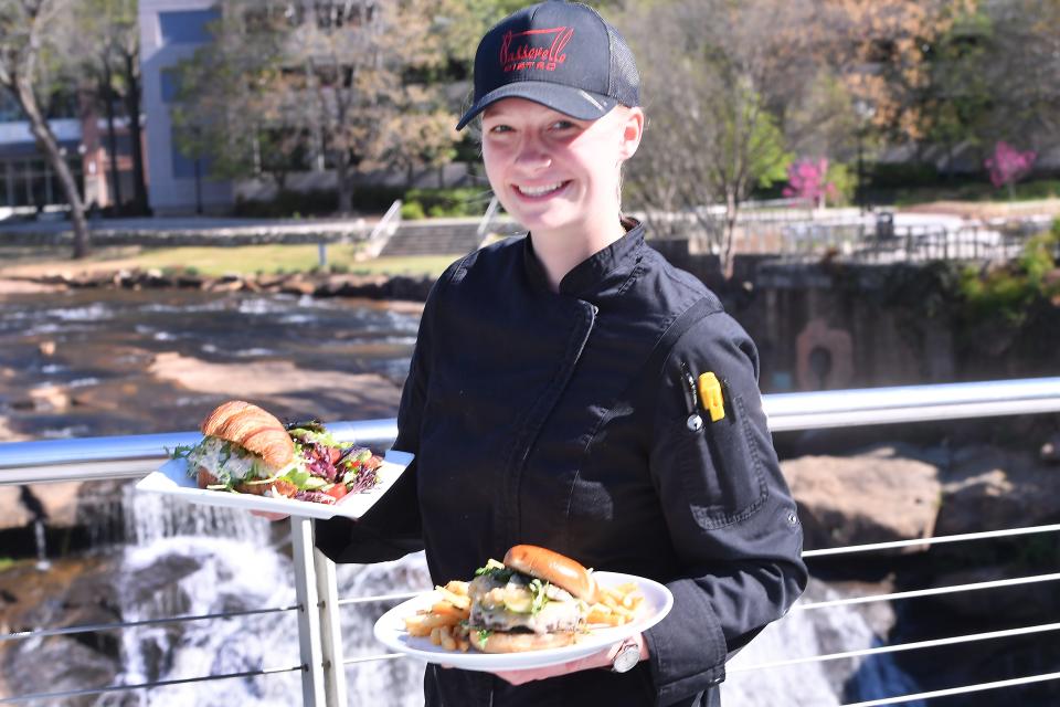 Passerelle Bistro in downtown Greenville will feature new items on their menu this Spring. Executive Chef Sydney Sobolewski holds a Spring Chicken Salad Croissant and Bistro Burger on Liberty Bridge in downtown Greenville. The restaurant is a stroll away from the bridge at Falls Park on the Reedy.