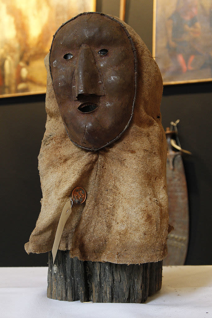 A primitive-looking mask with a cloth neck