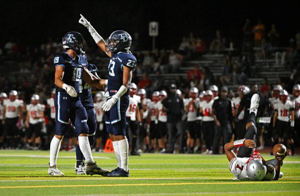 Downey’s Derrick Kirkendall signals to the sideline after sacking Lincoln quarterback Martin Tokmo during the non-league game at Downey High School in Modesto, Calif., Friday, August 18, 2023. 