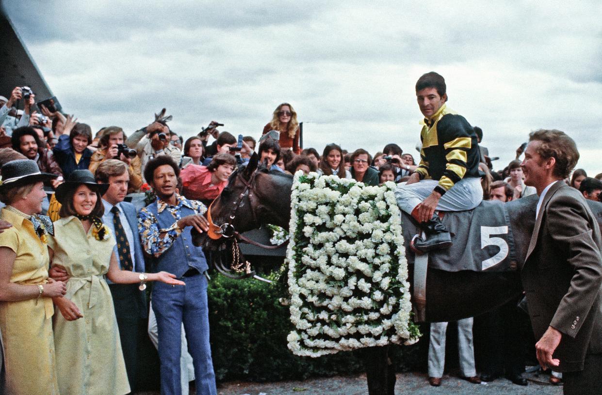 Jean Cruguet sits on Seattle Slew in the winner's circle, as trainer Billy Turner stands at right at Belmont Park in Elmont, N.Y., June 11, 1977, after the horse's win in the Belmont Stakes, and Triple Crown win. Turner died at the age of 81 on Dec. 31, 2021 in Reddick in north Marion County.