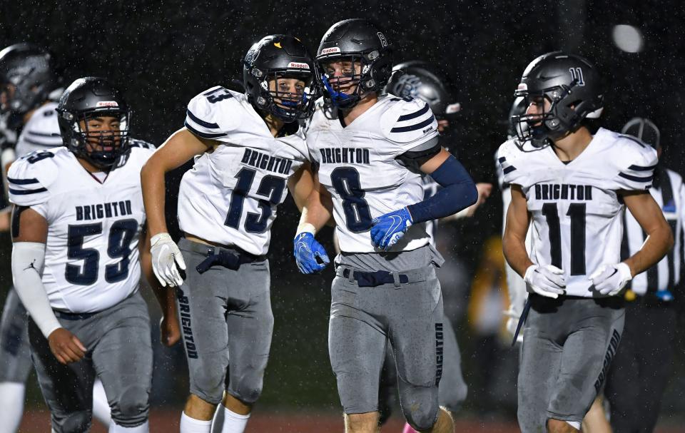 Brighton's Thomas Welker (8) celebrates with Jamin Close (59), Gavin Parks (13) and Kieran Hughes (11) after scoring against Spencerport during a regular season game at Spencerport High School, Friday, Oct. 7, 2022.