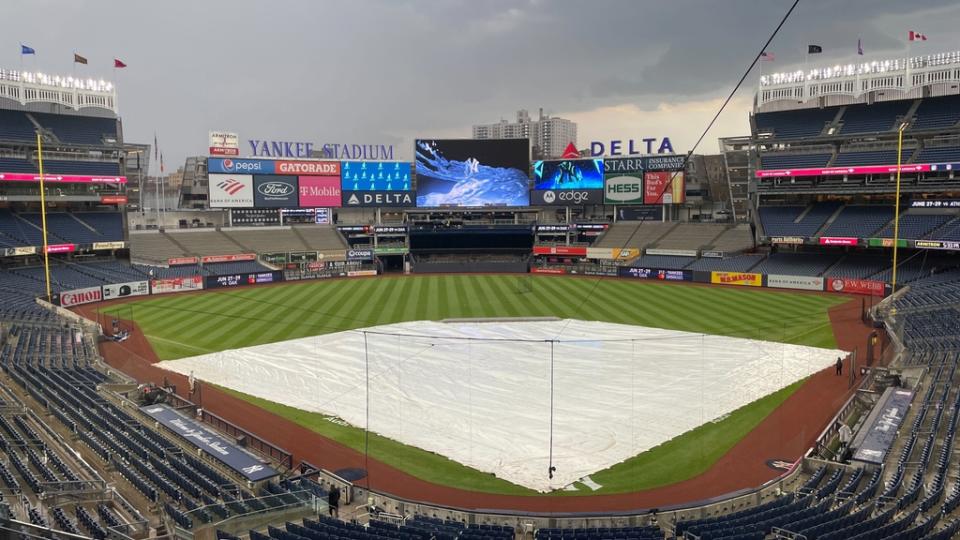 Yankee Stadium with the tarp on the field.