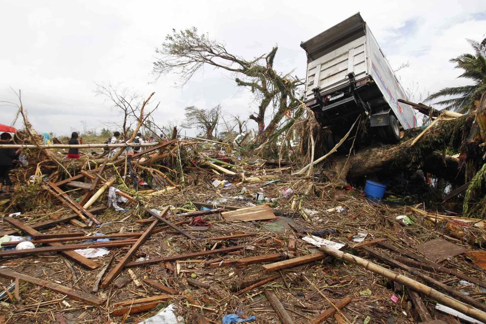 A truck is seen slammed on a tree after strong winds brought by super Typhoon Haiyan battered Tacloban city, central Philippines November 9, 2013. Typhoon Haiyan, the strongest typhoon in the world this year and possibly the most powerful ever to hit land battered the central Philippines on Friday, forcing millions of people to flee to safer ground, cutting power lines and blowing apart houses. Haiyan, a category-5 super typhoon, bore down on the northern tip of Cebu Province, a popular tourist destination with the country's second-largest city, after lashing the islands of Leyte and Samar with 275 kph (170 mph) wind gusts and 5-6 meter (15-19 ft) waves. REUTERS/Romeo Ranoco (PHILIPPINES - Tags: DISASTER ENVIRONMENT)