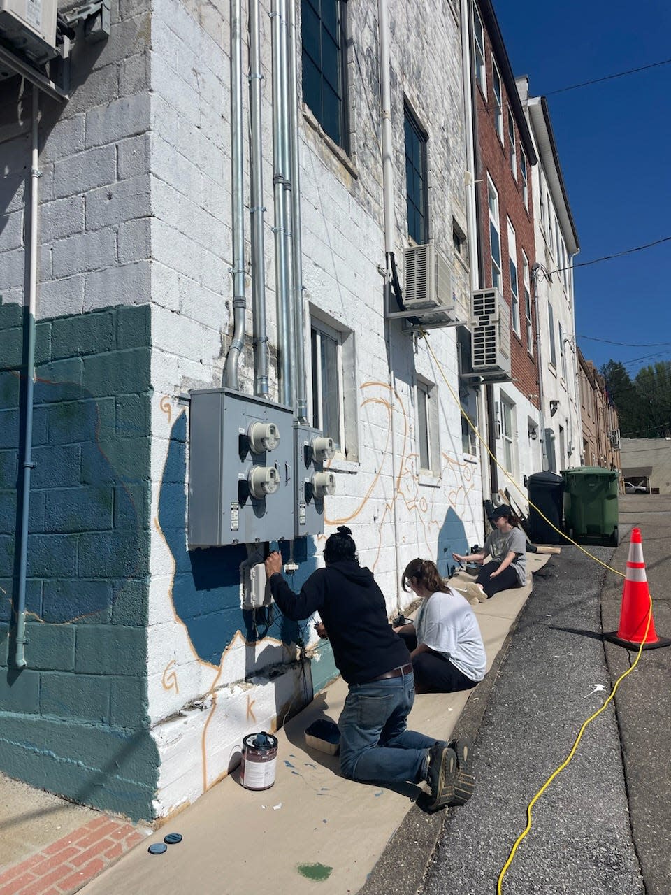 Artist Gabe Eng-Goetz and six apprentices, including three Mars Hill University art students, are working on a mural art project in downtown Mars Hill.