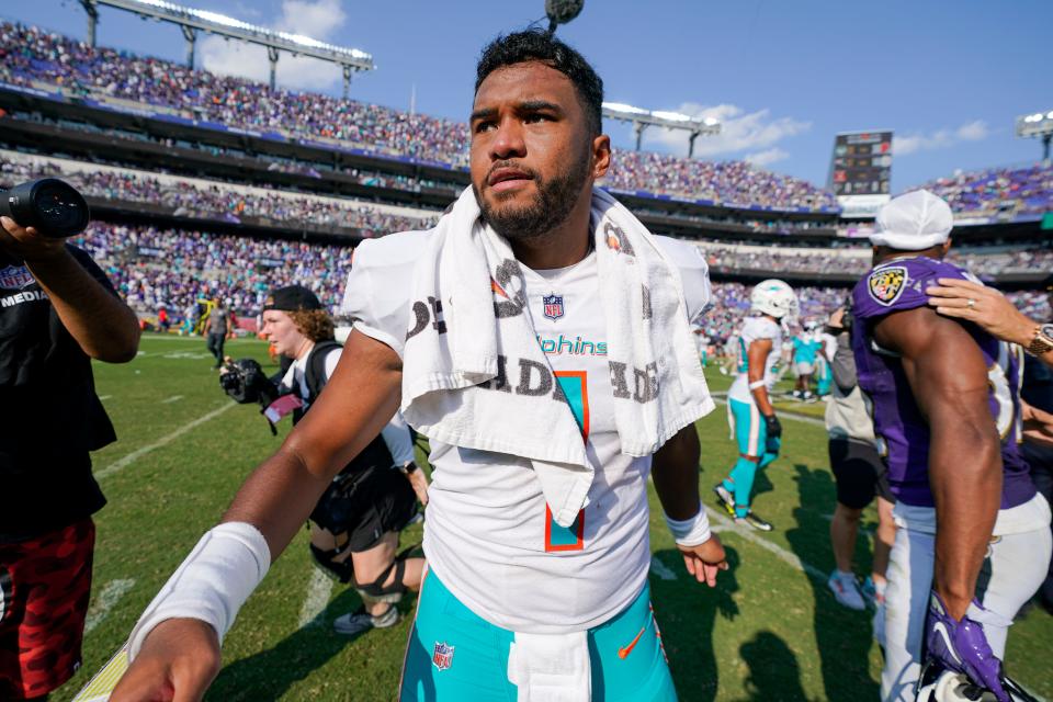 Tua Tagovailoa walks on the field after the Dolphins' win over the Ravens.