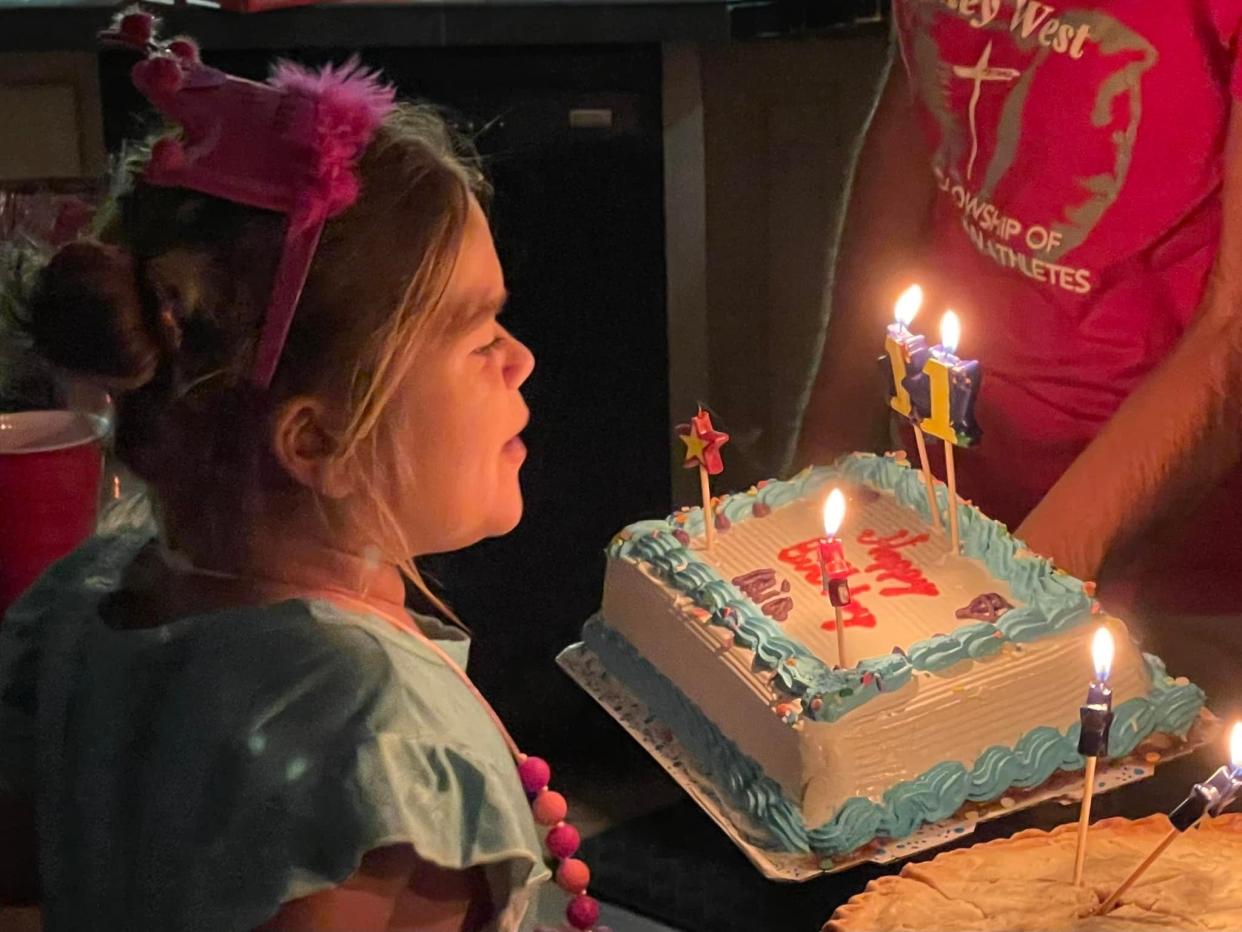 Mia Wilson blows out candles on a cake for her 11th birthday on Feb. 19.