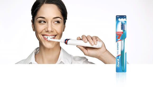 Woman brushing teeth with Oral-B toothbrush