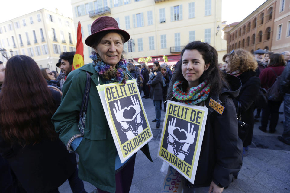 This Jan. 4, 2017 photo shows supporters holding placards reading "Solidarity Offence " as they support Cedric Herrou, a French activist farmer accused of helping African migrants to cross the border from Italy, in Nice, southern France. A French appeals court is expected to hand down a verdict Thursday afternoon in the case of a mountain guide who was convicted for helping migrants enter the country illegally. (AP Photo/Claude Paris, File)