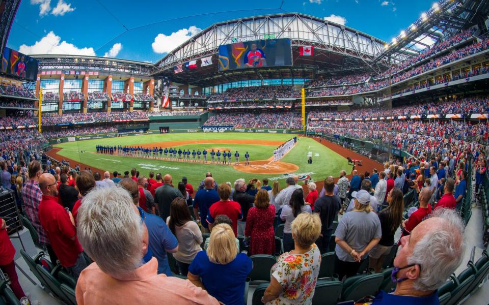 A view of the field and the fans and the ballpark and the players during the playing of US and Canadian national anthems before the game between the Texas Rangers and the Toronto Blue Jays at Globe Life Field