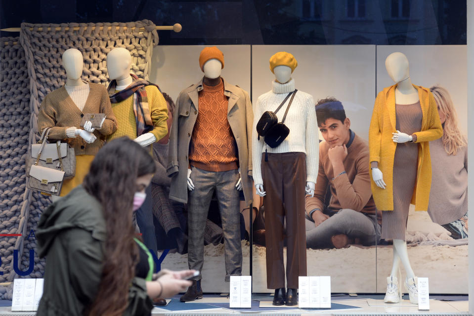 Woman in mask walks past retail stores in the Czech Republic. Source: AP