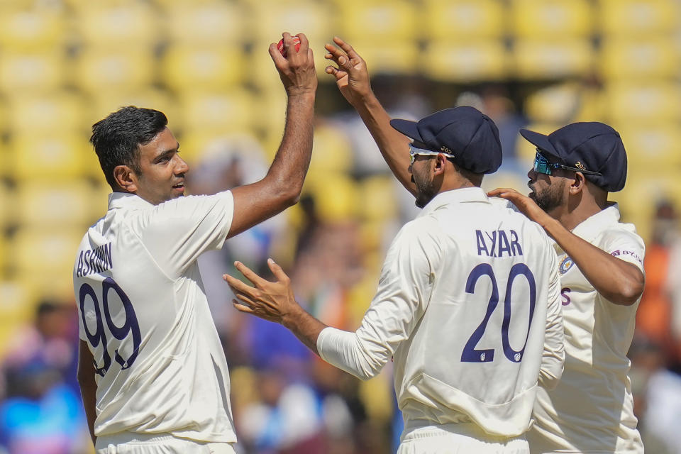 India's Ravichandran Ashwin, left, celebrates his five-wicket haul with his teammates after the dismissal of Australia's Alex Carey during the third day of the first cricket test match between India and Australia in Nagpur, India, Saturday, Feb. 11, 2023. (AP Photo/Rafiq Maqbool)