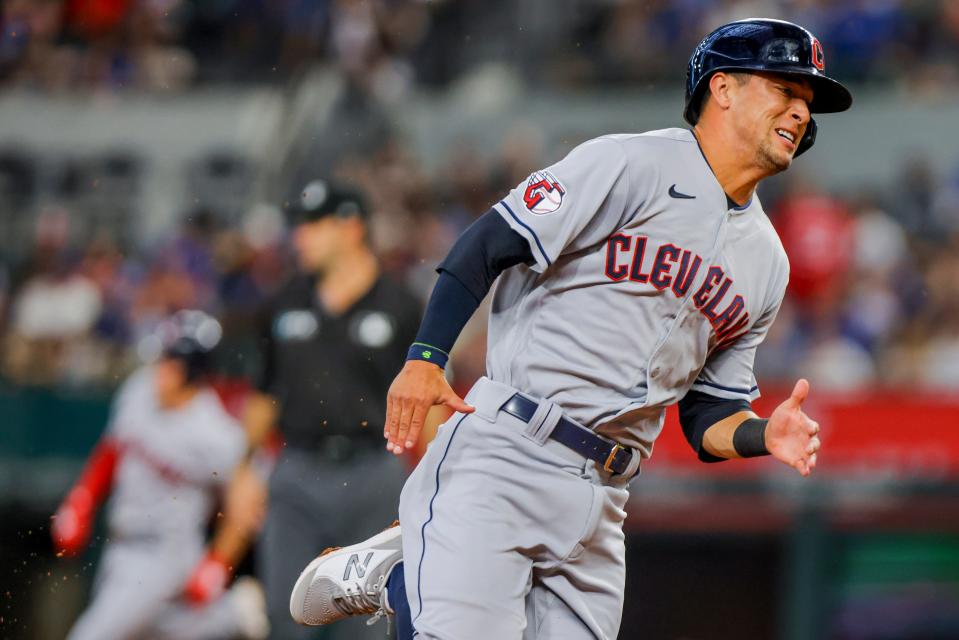 Cleveland Guardians'  Tyler Freeman, right, scores on a single by Steven Kwan during the third inning against the Texas Rangers in Arlington, Texas on Sept.  25, 2022.