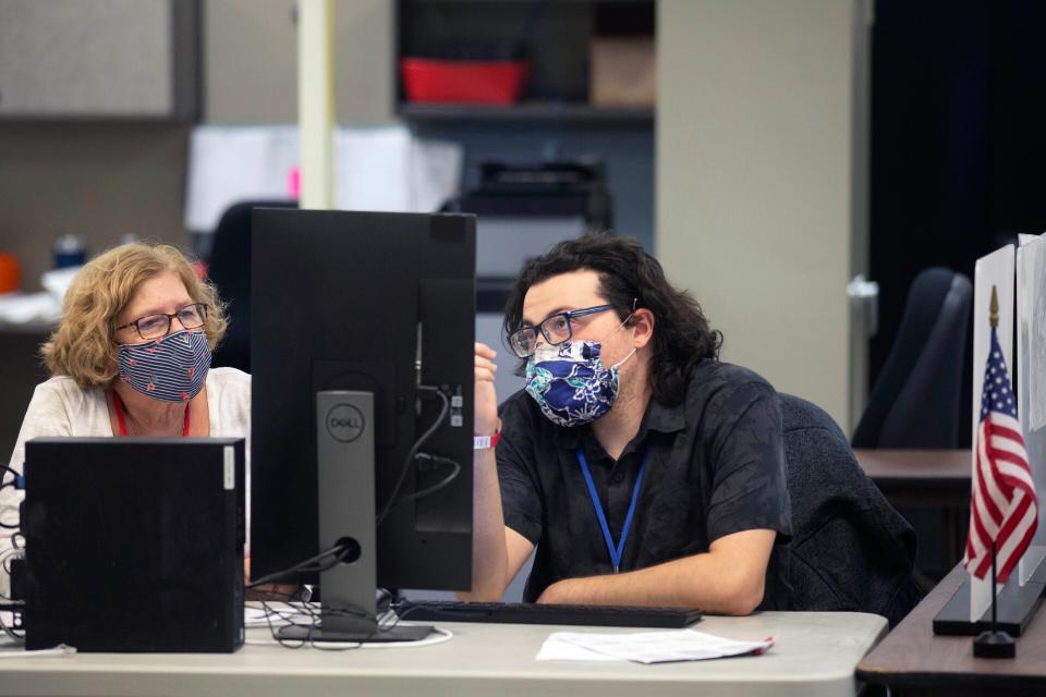 A bipartisan pair of ballot analysts at the Maricopa County Recorder's Office in Phoenix on Nov. 5, 2020.