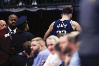 Dallas Mavericks guard Luka Doncic, top right, leaves after suffering a right heel contusion during the second half of an NBA basketball game against the New Orleans Pelicans, Thursday, Feb. 2, 2023, in Dallas. (AP Photo/Brandon Wade)