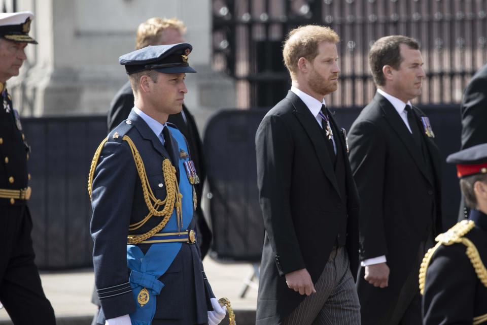 Prince William, left, and Prince Harry walk behing the coffin of Queen Elizabeth II during a procession from Buckingham Palace to the Palace of Westminster, in London, on September 14, 2022.  / Credit: Rasid Necati Aslim/Anadolu Agency via Getty Images