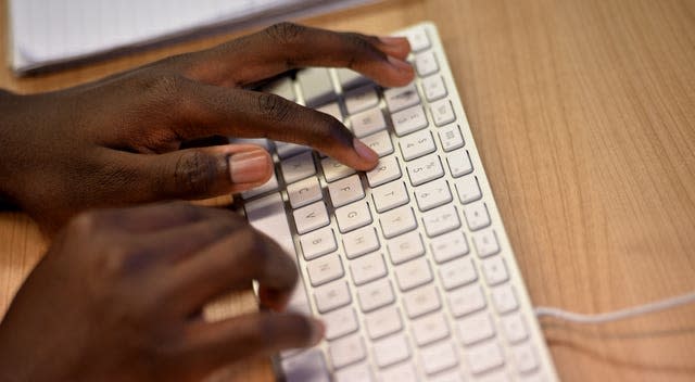 A man typing on a keyboard