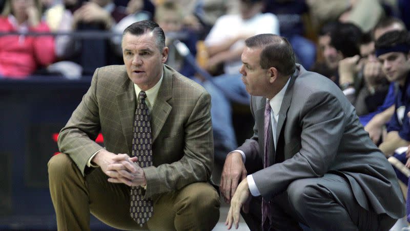 BYU coaches Steve Cleveland and Dave Rose converse during game against Colorado State in Provo, Utah Feb. 14, 2005.