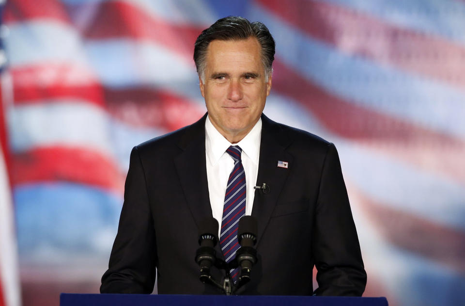 Mitt Romney stands at a podium