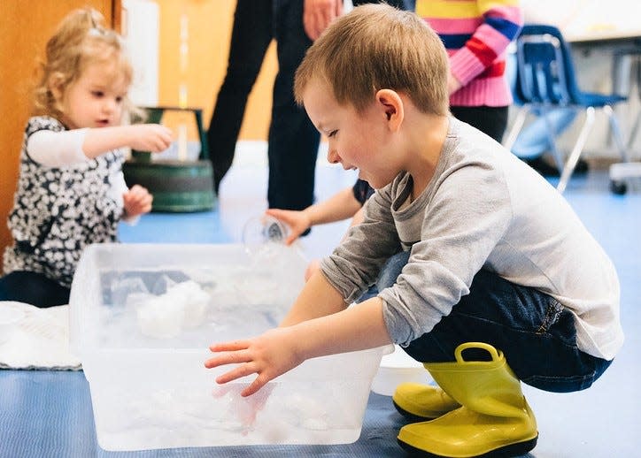 A child participates in a preschool event at the Monroe County Public Library's downtown branch.