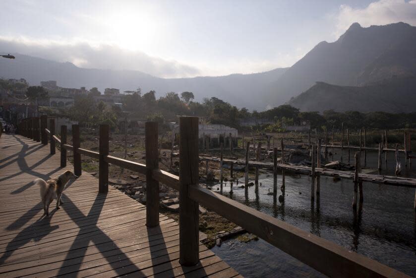 The hill known as "Mayan face" or "Indian nose" is seen from the dock at the Mayan Tz'utujil community of San Juan La Laguna, on lake Atitlan, Guatemala, Tuesday, March 12, 2019. An English tourist whose body was found near the Guatemala highland lake popular with travelers died of hemorrhaging resulting from a traumatic brain injury, according to an autopsy report completed Tuesday. (AP Photo/Santiago Billy)