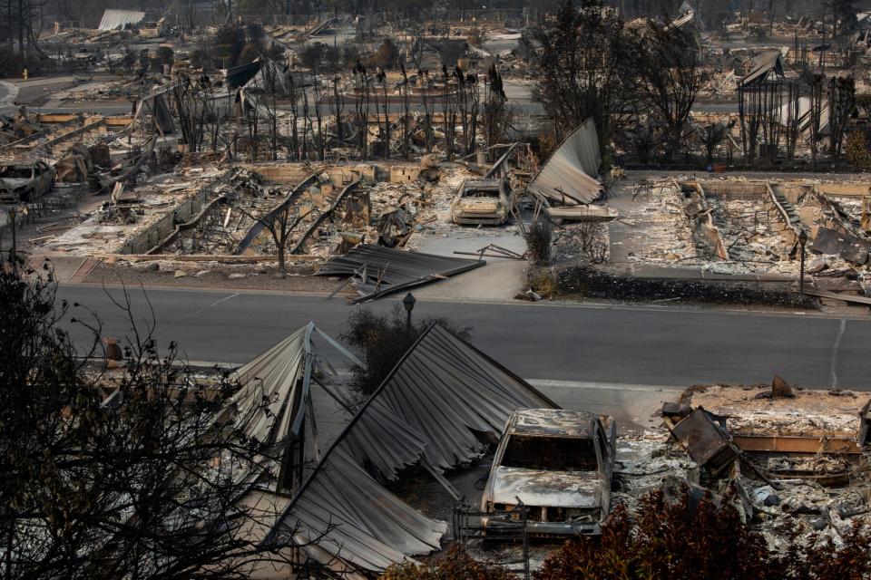 A neighbourhood is destroyed by the fires (AP)