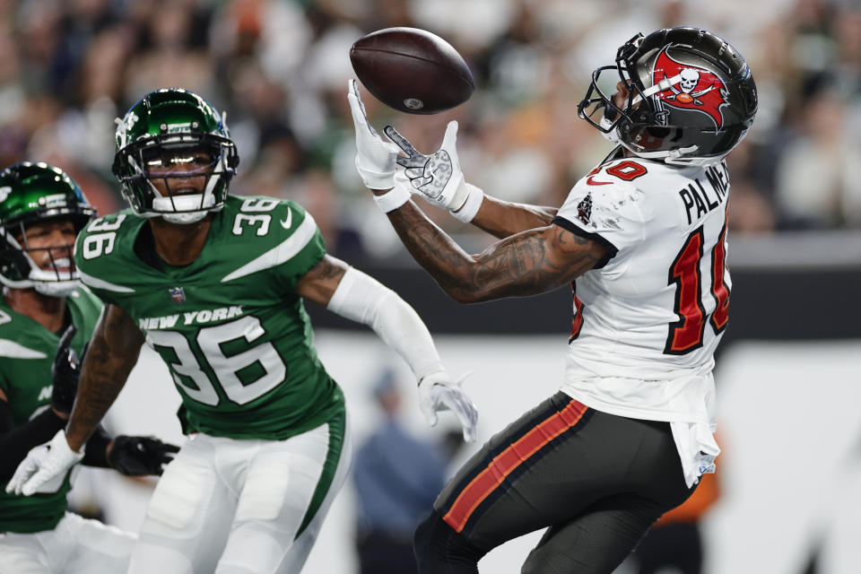 Tampa Bay Buccaneers wide receiver Trey Palmer (10) catches a pass for a touchdown in front of New York Jets cornerback Derrick Langford (36) during the first half of a preseason NFL football game, Saturday, Aug. 19, 2023, in East Rutherford, N.J. (AP Photo/Adam Hunger)